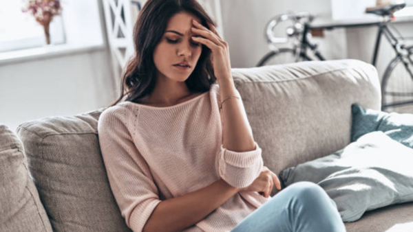 Exhausted woman resting her head on a desk