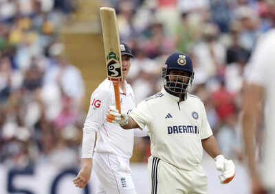 Rishabh Pant celebrates reaching a milestone.